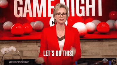 A Woman In A Red Jacket Says Let 'S Do This In Front Of A Game Night Sign GIF