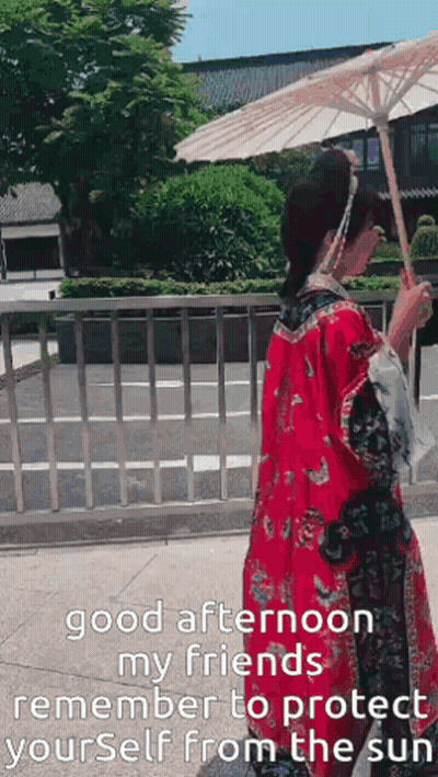 A Woman In A Red Kimono Is Holding An Umbrella And Says Good Afternoon My Friends GIF