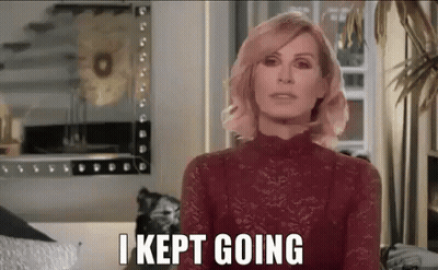 A Woman In A Red Lace Top Is Standing In Front Of A Mirror And Says `` I Kept Going '' . GIF