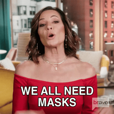 A Woman In A Red Off The Shoulder Top Is Saying We All Need Masks GIF