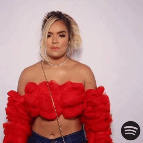 A Woman In A Red Off The Shoulder Top GIF