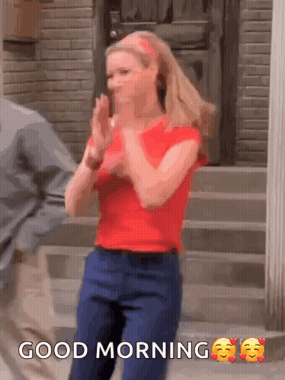 A Woman In A Red Shirt Is Clapping Her Hands And The Words Good Morning Are Above Her GIF