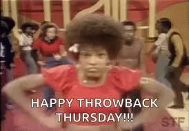 A Woman In A Red Shirt Is Dancing In Front Of A Crowd Of People And Says `` Happy Throwback Thursday '' . GIF