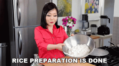 A Woman In A Red Shirt Is Holding A Bowl Of Rice With The Words Rice Preparation Is Done Above Her GIF