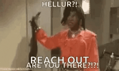 A Woman In A Red Shirt Is Holding A Gun And Says `` Hellur ? Reach Out Are You There ? '' . GIF