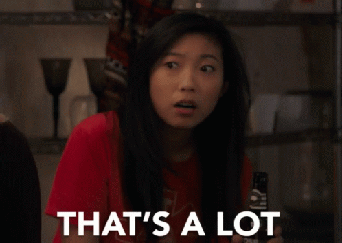 A Woman In A Red Shirt Is Holding A Remote Control And Says That 'S A Lot GIF