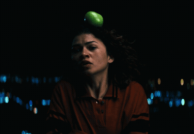 A Woman In A Red Shirt Is Looking At The Camera GIF