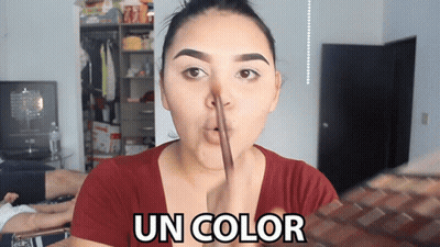 A Woman In A Red Shirt Is Making A Funny Face And The Words Un Color Are Above Her Face GIF