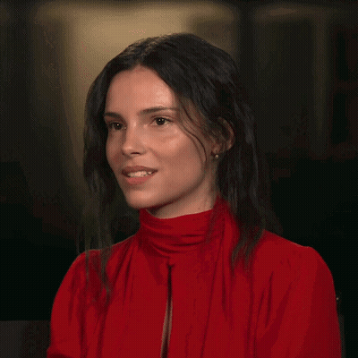 A Woman In A Red Shirt Is Pointing Her Finger GIF