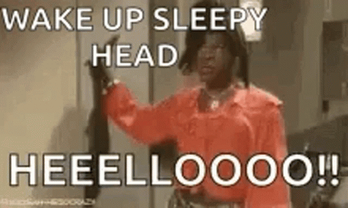 A Woman In A Red Shirt Is Saying `` Wake Up Sleepy Head Heeelloooo !! '' GIF