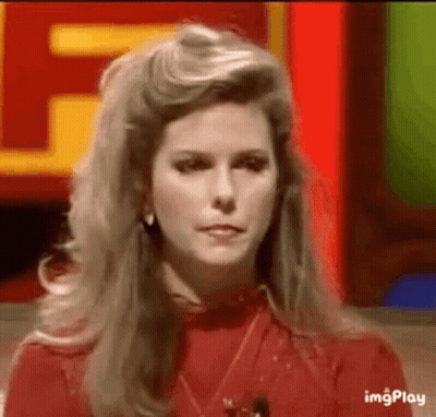 A Woman In A Red Shirt Is Sitting In Front Of A Red Sign . GIF