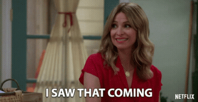 A Woman In A Red Shirt Is Smiling And Says I Saw That Coming GIF