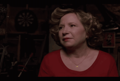 A Woman In A Red Shirt Says Trademicros In Yellow Letters GIF