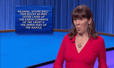 A Woman In A Red Shirt Stands In Front Of A Sign That Says " What " GIF