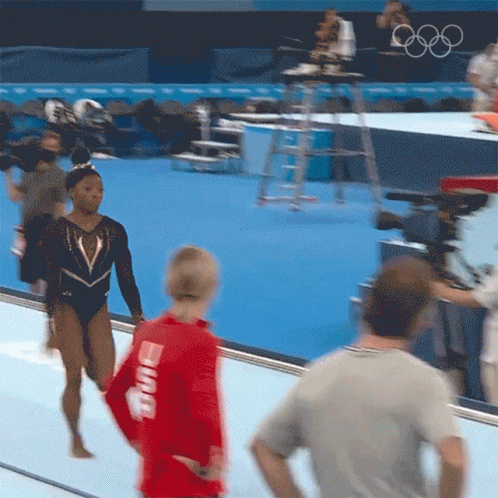 A Woman In A Red Shirt That Says ' Smith ' On The Back Of It GIF