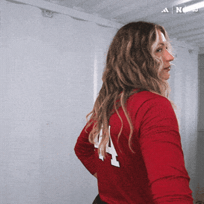 A Woman In A Red Shirt With The Number 4 On It GIF