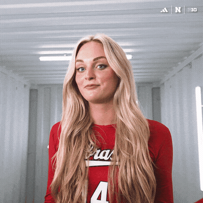A Woman In A Red Shirt With The Number 4 On The Front GIF
