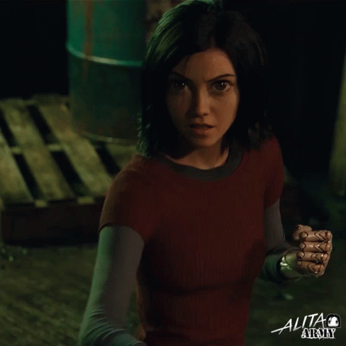 A Woman In A Red Shirt With The Word Alita At The Top GIF