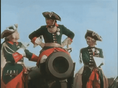 A Woman In A Red Skirt Is Flying Through The Air Holding A Giant Ball . GIF