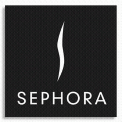 A Woman In A Red Suit Is Standing In Front Of The Sephora Logo GIF
