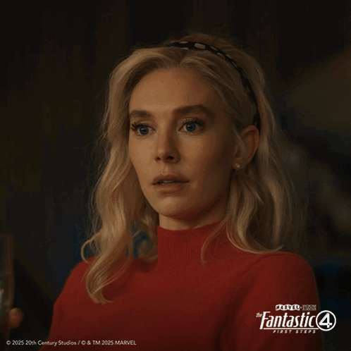 A Woman In A Red Sweater Is Holding A Glass Of Water In Front Of A Poster For The Fantastic 4 First Steps GIF