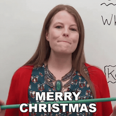 A Woman In A Red Sweater Is Holding A Green Pencil And Says Merry Christmas GIF