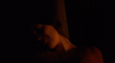 A Woman In A Red Sweater Is Smiling With The Words Digging Holes For Posts Below Her GIF