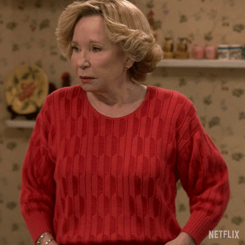 A Woman In A Red Sweater Says Booyah To Both Of You Netflix GIF