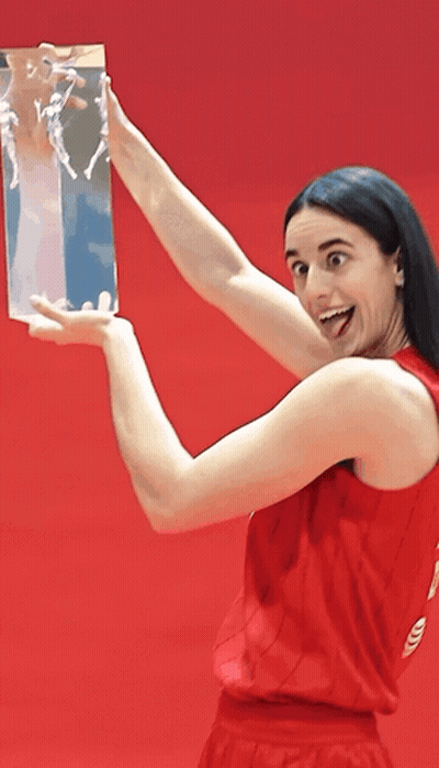 A Woman In A Red Tank Top Holds A Trophy In Her Hands GIF