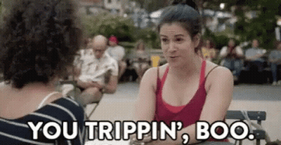 A Woman In A Red Tank Top Is Sitting At A Table With Another Woman . GIF