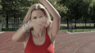 A Woman In A Red Tank Top Is Throwing A Basketball GIF