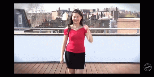 Woman In Red Top And Black Skirt On Balcony GIF