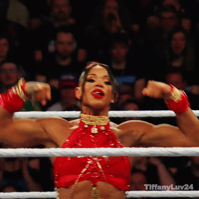 A Woman In A Red Top Flexes Her Muscles In A Boxing Ring With Tiffanyluv24 Written On The Bottom GIF