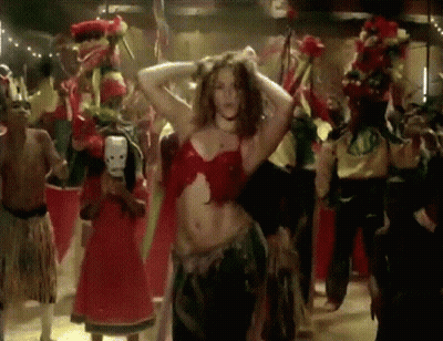 A Woman In A Red Top Is Dancing With A Group Of People GIF