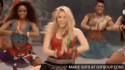 A Woman In A Red Top Is Dancing With A Group Of Women . GIF