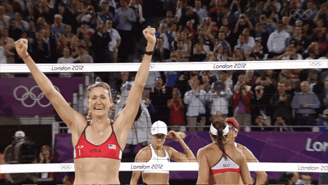 A Woman In A Red Top With The Letter F On It Stands In Front Of A Net That Says London 2012 GIF