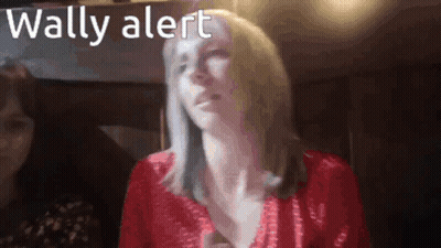 A Woman In A Red Top With The Words Wally Alert Below Her GIF