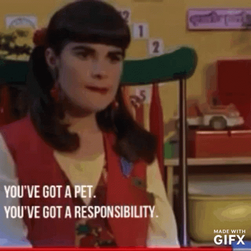 A Woman In A Red Vest Is Sitting In A Chair In A Room And Talking To Someone . GIF