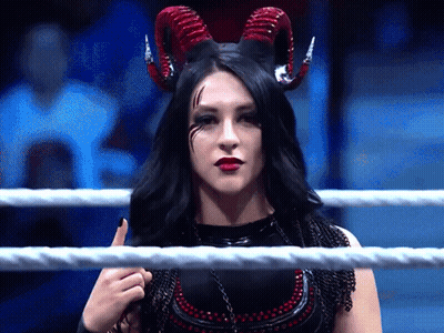 A Woman In A Ring With Horns On Her Head GIF