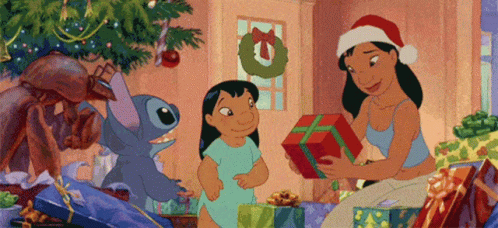 A Woman In A Santa Hat Is Giving A Gift To A Child In Front Of A Christmas Tree . GIF