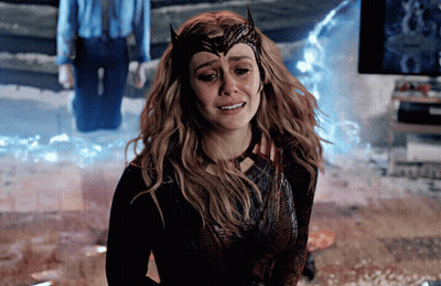 A Woman In A Scarlet Witch Costume Is Crying With Tears Running Down Her Face GIF