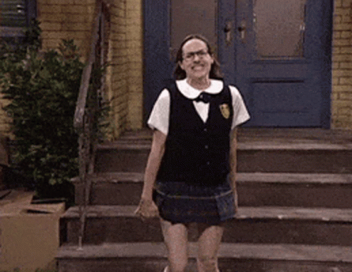 A Woman In A School Uniform Is Dancing On The Stairs GIF