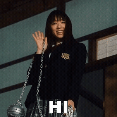 A Woman In A School Uniform Is Holding A Chain And Waving With The Phrase Hi Below Her GIF