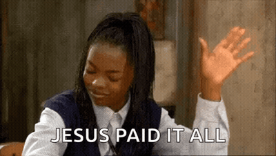 A Woman In A School Uniform Is Sitting At A Table With Her Hands In The Air And Says `` Jesus Paid It All '' . GIF