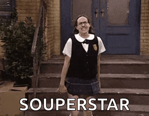 A Woman In A School Uniform Is Standing On A Set Of Stairs In Front Of A Door . GIF