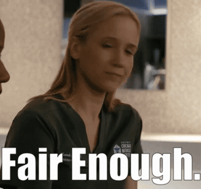 A Woman In A Scrub Top With The Words Fair Enough On The Bottom GIF