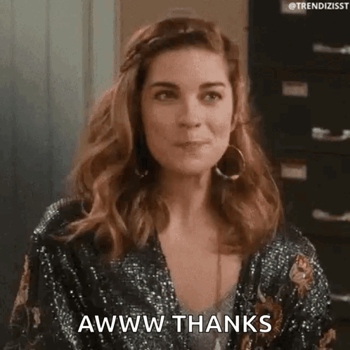 A Woman In A Sequined Jacket Is Making A Funny Face And Saying Awww Thanks . GIF