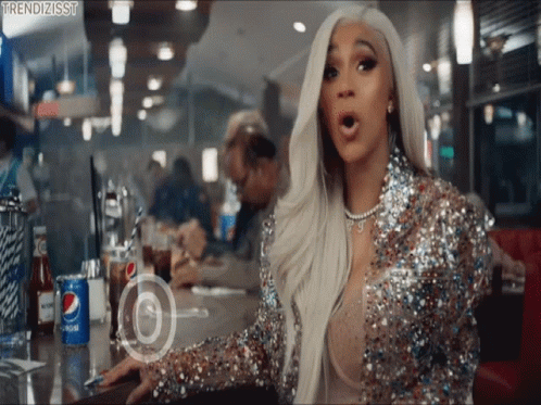 A Woman In A Sequined Jacket Is Sitting At A Diner Table With A Can Of Pepsi In Front Of Her GIF