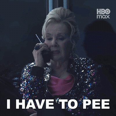 A Woman In A Sequined Jacket Is Talking On A Cell Phone And The Caption Says " I Have To Pee " GIF