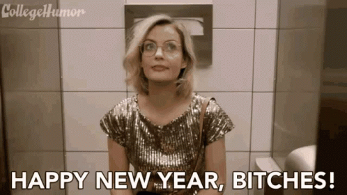 A Woman In A Sequined Top Says " Happy New Year Bitches " In A Bathroom GIF